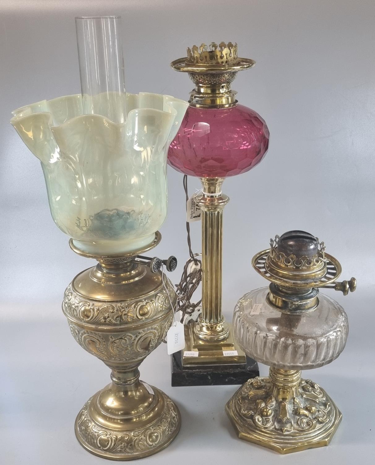 Early 20th century double oil burner lamp with frilled glass shade on a brass reservoir and base