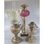 Early 20th century double oil burner lamp with frilled glass shade on a brass reservoir and base