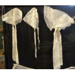 Collection of antique baby's bonnets; one fine bobbin lace, one floral embroidered tulle and a