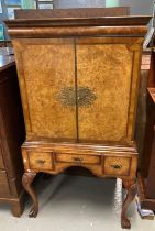 Reproduction walnut two door blind panelled cocktail cabinet, with brass lock and mounts, the