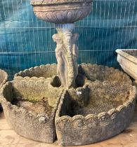 Reconstituted stone garden bird bath with figural pedestal and segmented planters around the base.