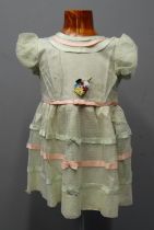 Two similar vintage early 20th Century children's tulle and ribbon embroidered dresses; one with