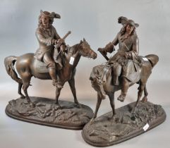 Pair of spelter Cavalier type figurines on horseback standing on a naturalistic oval base. (2) (B.P.