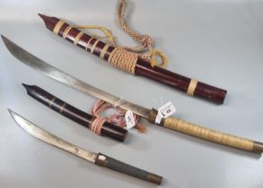 Two Indonesian bladed weapons to include: short sword/dagger and curved sword. (2) (B.P. 21% + VAT)