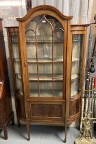 Edwardian mahogany inlaid bow front display cabinet standing on tapering legs and spade feet. (B.