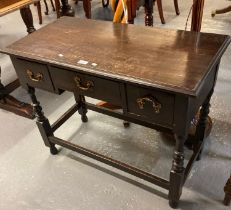 Early 20th century oak dresser base of small proportions, the moulded top above an arrangement of