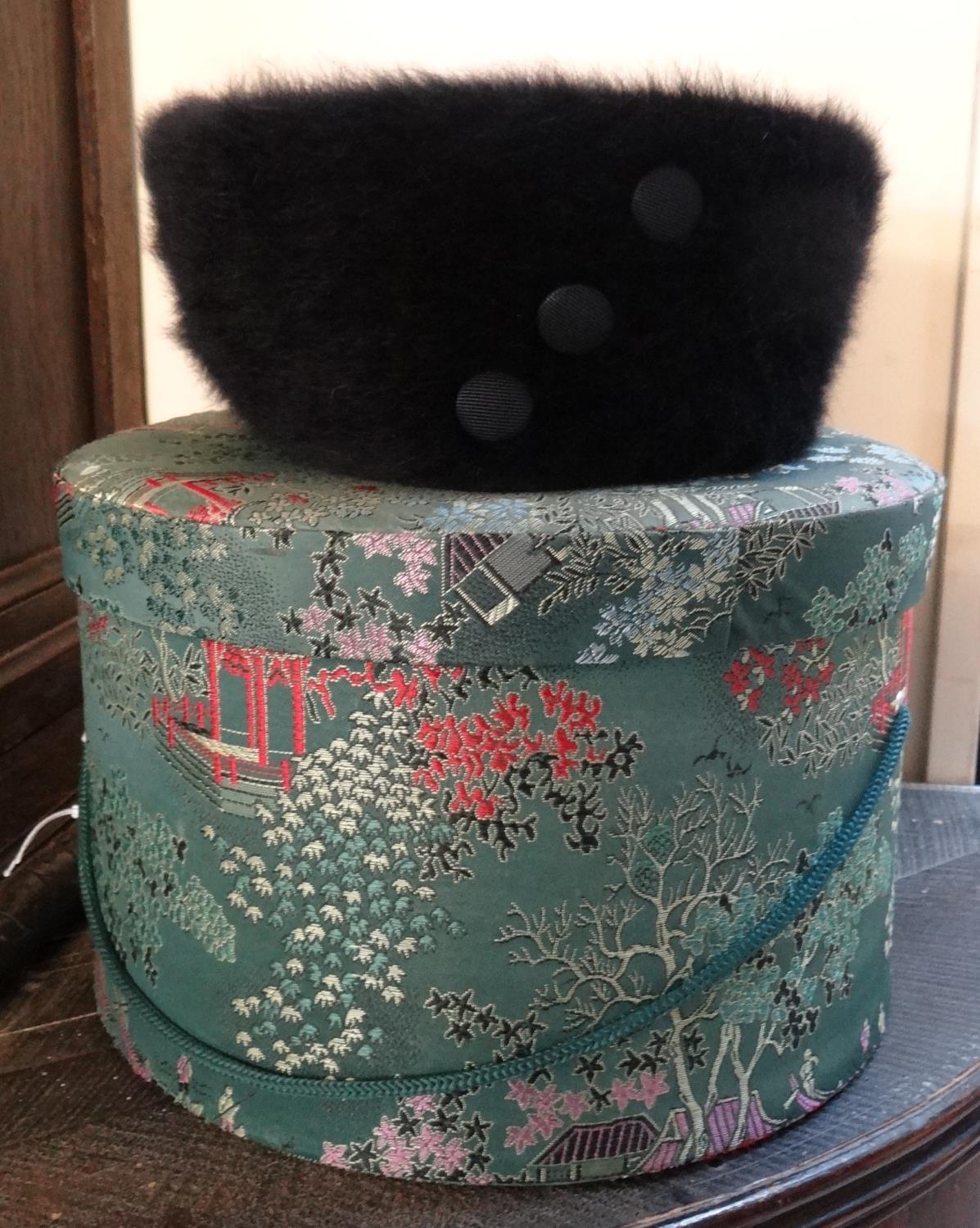 Vintage Chinese silk hatbox containing a Kangol black pillbox hat with button detail. (B.P. 21% +