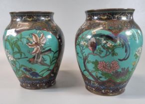 a near pair of Japanese cloisonné vases depicting birds, flowers and foliage on a brocade ground.