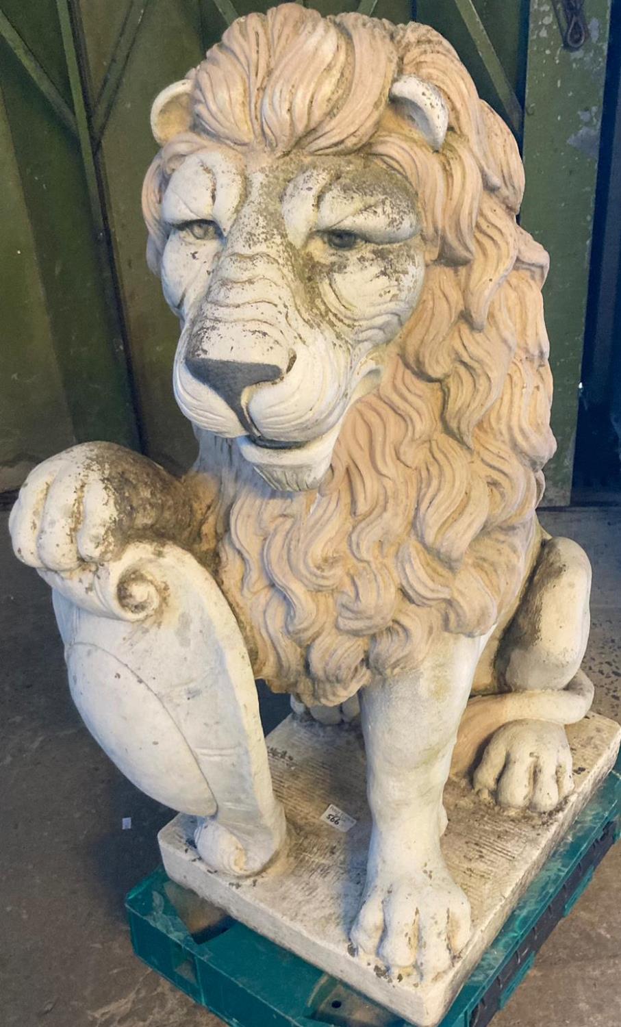 Large pair of reconstituted stone male lions, seated with shields. Maker's name 'H E I Studio'? (B.