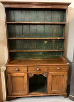 19th century oak dog kennel dresser, the moulded cornice above painted boarded back, the