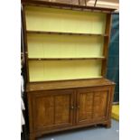Grained/scumbled pine kitchen dresser with boarded two shelf rack back above base with two panel