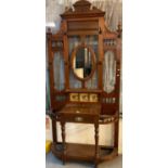 Edwardian mahogany hall stand with oval mirror back and inset tile decoration, glove drawer on