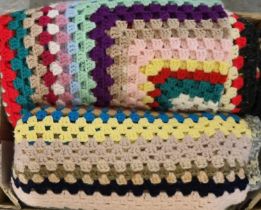 Box containing two multi-colour crochet woollen blankets or throws, one with tasselled corners. (B.