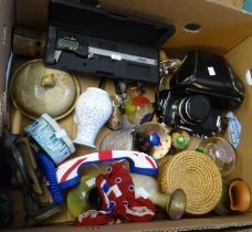 Box of oddments to include: carved lighthouse, vintage Nikomat camera with case, Thai figure,