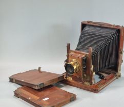 A Beck mahogany brass mounted folding plate camera with 'Beck' symmetrical lens. 6 x 5" plate