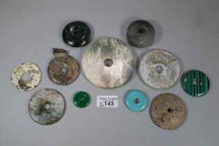 A collection of unusual Chinese 'Bi' discs to include varying designs and hardstones including;