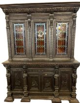 19th Century Flemish design ebonised library bookcase, overall heavily carved with heraldic shields,