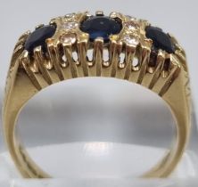 18ct gold diamond and sapphire ring, comprising six tiny diamonds and three sapphire stones. 6.5g