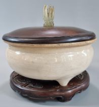 17th Century Chinese porcelain 'Dehua Blanc-de-chine' tripod censer, on a carved hardwood stand