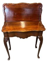 18th Century mahogany serpentine fronted fold-over tea table, the top with moulded edges, above a