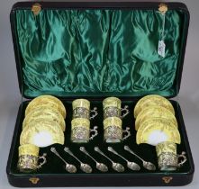 Early 20th century cased set of six porcelain coffee cans and saucers with silver overlay mounts and