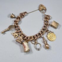 Victorian 9ct gold curb link charm bracelet with assorted charms including: heart shaped padlock,