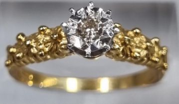 18ct gold diamond solitaire illusion set ring with moulded floral designs to each shoulder. 3g