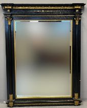 19th Century ebonised mirror, the moulded stepped top or cornice above gilt foliate decoration and