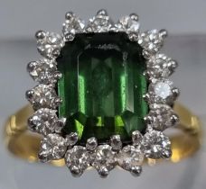 18ct gold diamond seventeen stone ring inset with central faceted green stone. 4.8g approx. Ring