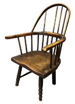 19th Century stick back primitive fireside elbow chair with moulded elm seat on turned legs. (B.P.