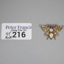 9ct gold brooch in the form of a butterfly, the wings inset with seed pearls, the body with two opal