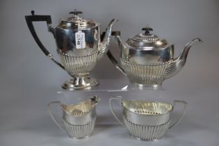 Georgian style silver four piece tea/coffee service with fluted design and ebonised handle