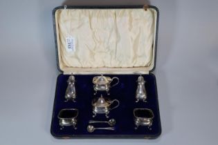 George V silver cased six piece condiment set with blue glass linings. Birmingham hallmarks. 7.45