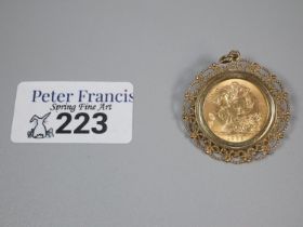 Queen Elizabeth II gold full sovereign in ornate 9ct gold pendant and brooch mount. 12.3g approx. (