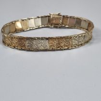 9ct gold ladies multi link bracelet, each panel decorated with roses, foliage etc. 19cm long, 16.