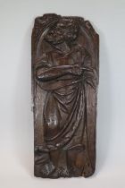 Ecclesiastical carved oak figural panel, probably depicting a Saint in arched niche. 16th century.