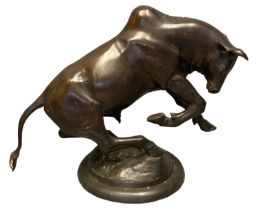 Large and impressive bronze sculpture of a charging bull , on circular naturalistic base.