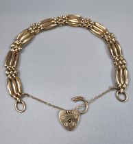 9ct gold three bar gate bracelet with heart shaped padlock. 15.2g approx. (B.P. 21% + VAT)