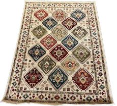 Ivory ground Ziegler full pile rug, overall with diamond medallion, floral and foliate designs.