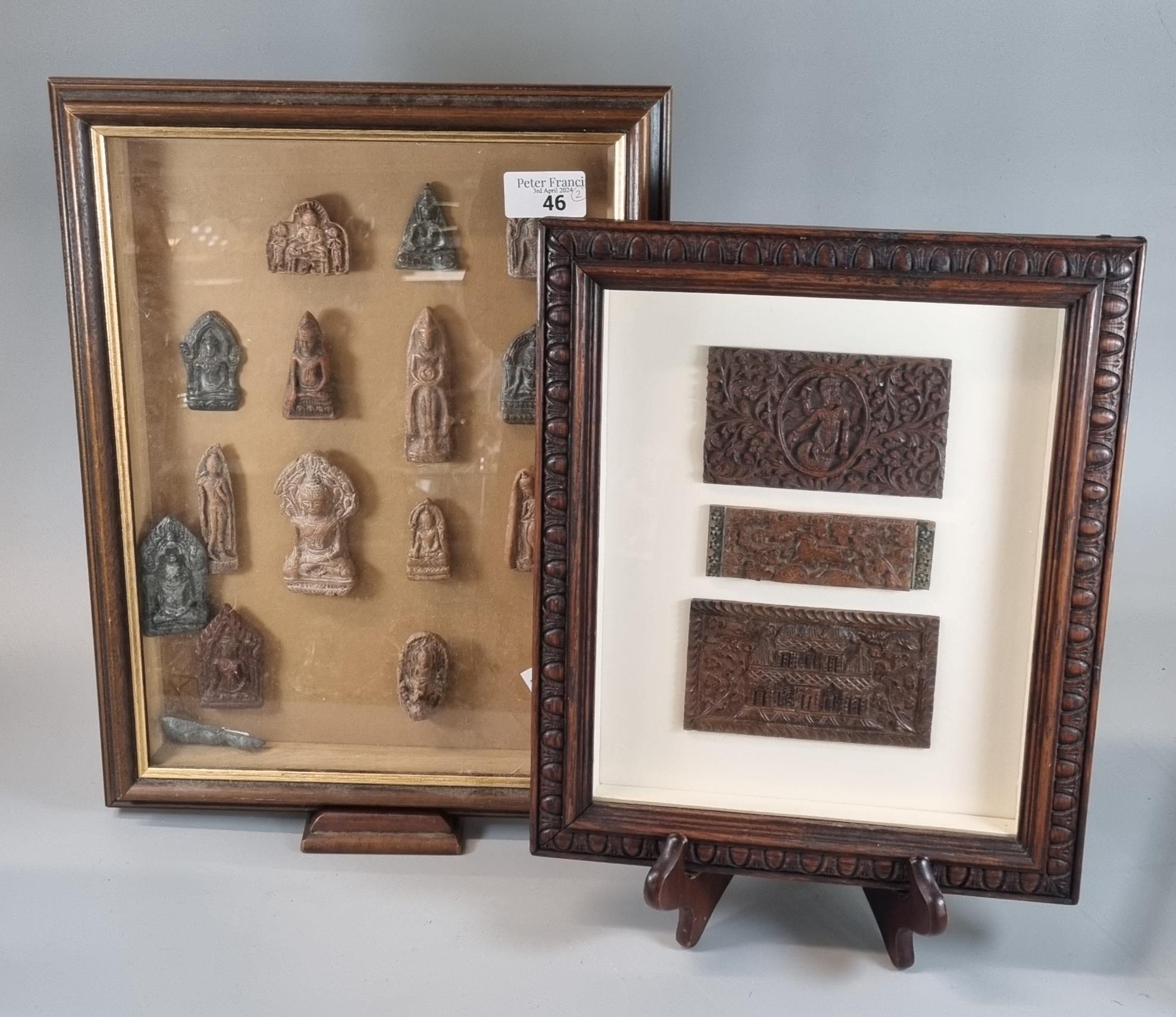 Group of appearing carved devotional figures mounted in a wooden glass fronted display frame