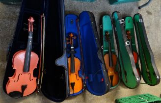 Box containing three cased student violas and one student violin to include: two Stentor student