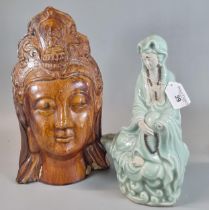 Oriental amber glazed head of the Buddha together with a polychrome figure of a seated Guanyin The