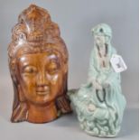 Oriental amber glazed head of the Buddha together with a polychrome figure of a seated Guanyin The