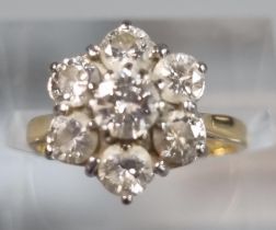 18ct gold seven stone flower head ring. 3g approx. Size J. (B.P. 21% + VAT)