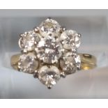 18ct gold seven stone flower head ring. 3g approx. Size J. (B.P. 21% + VAT)