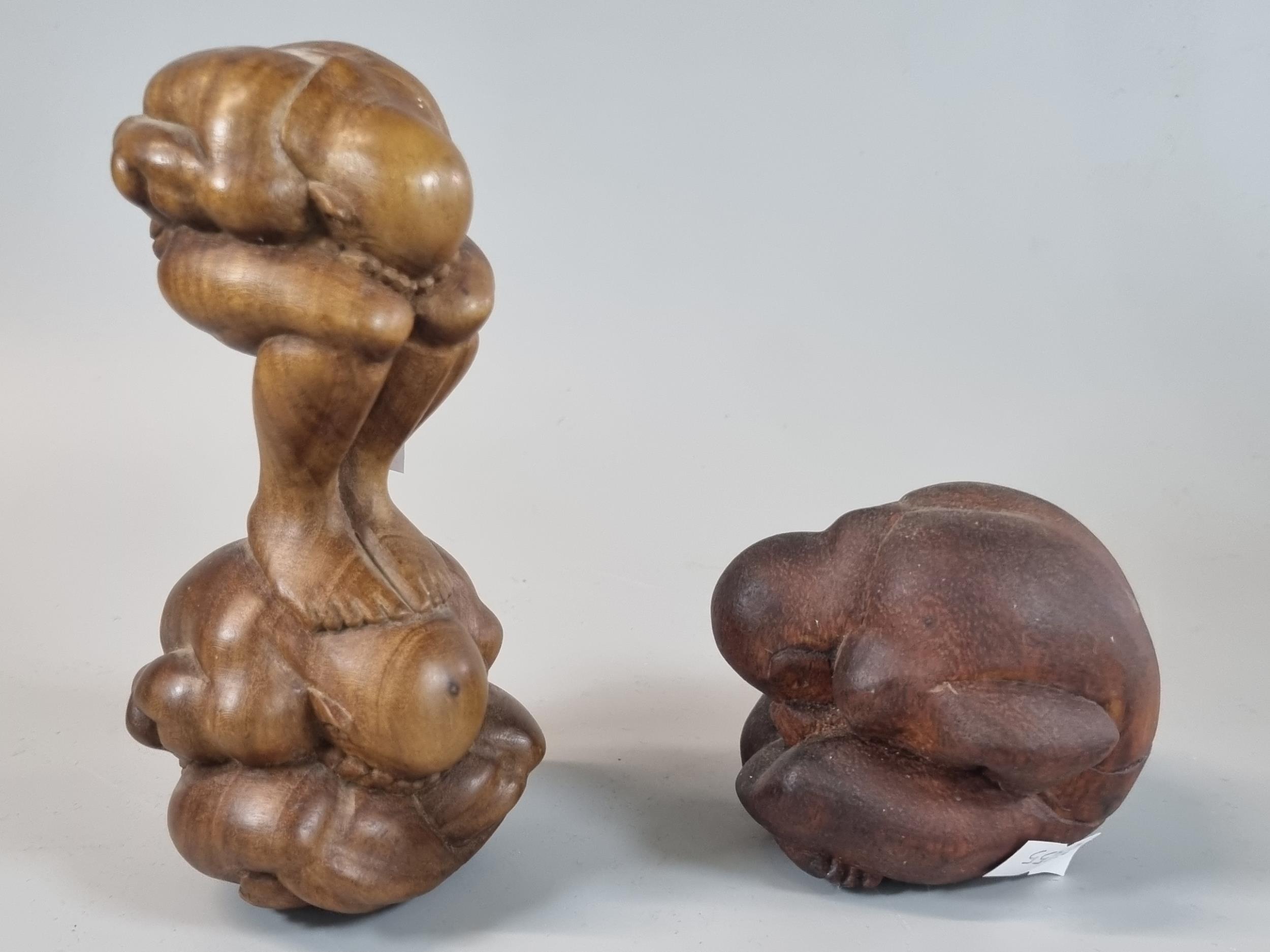 Two wooden hardwood sculptures of nude crouched men, one seated with all hands on their face. (2) (