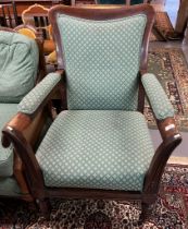 Victorian rosewood open armchair with stuff over seat standing on turned fluted legs and casters. (