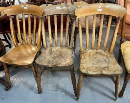 Three similar late Victorian elm and beech slat back kitchen chairs on moulded seats and turned