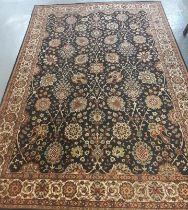 Large Middle Eastern style blue ground floral and foliate carpet with repeating floral borders.