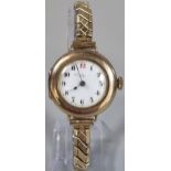 Vintage 9ct gold cushion shaped circular wristwatch with Arabic numerals to the enamel face on